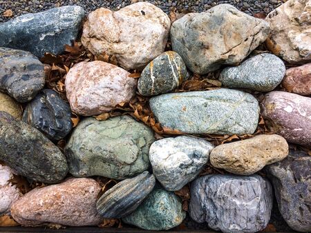 Stones and dry leaves. texture of cobblestone. Large stonesの写真素材