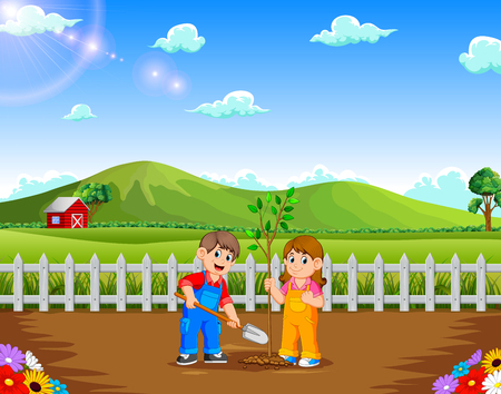Boy and Girl planting tree in the parkの写真素材