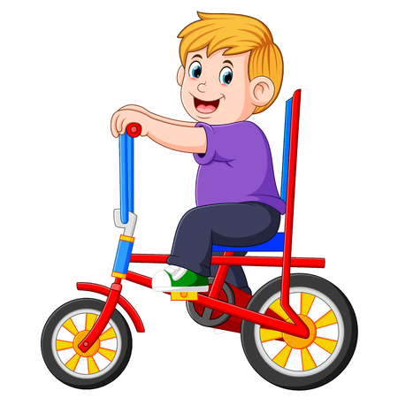the boy is cycling on the colorful bicycleの写真素材