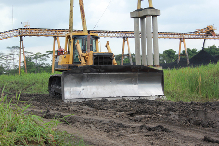 Bulldozer stand by near conveyor ready for useの写真素材