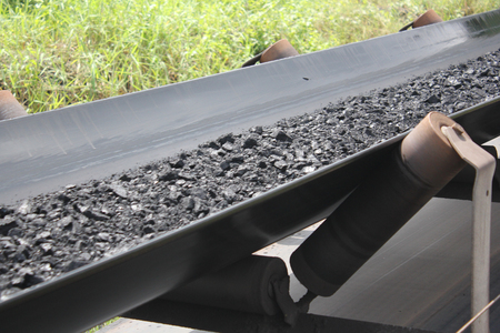 Black coal passing above belt conveyor to jettyの写真素材