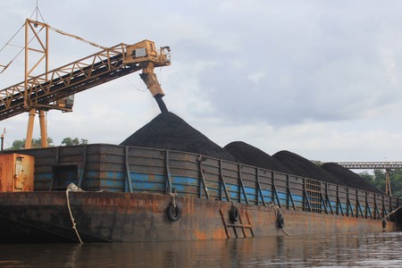Coal barge loading process on the mahakam riverの写真素材