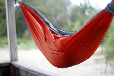 Red Hammock hanging between two pillarの写真素材