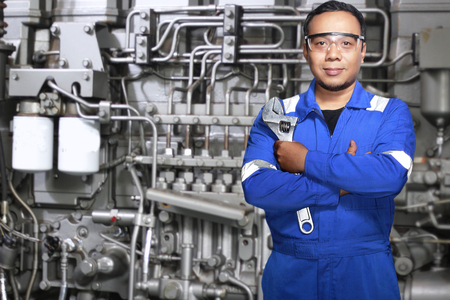 Portrait of Asian an mechanic engineer with machine backgroundの写真素材