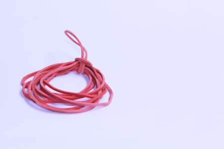 some of rubber band red united  with white backgroundの写真素材