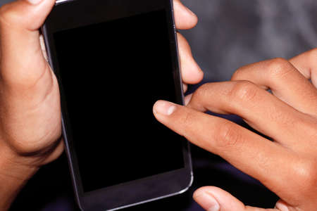 hand holding phone mobile and touching screen. example concept for using application like as fintect,vaccine data,etc.の写真素材