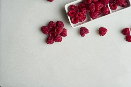 Fresh raspberries in a white ceramic bowl . Food, healthy. Copy space