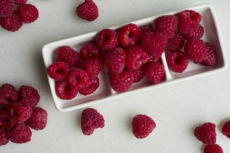 Crockery with beautiful tempting raspberries. Copy spaceの写真素材