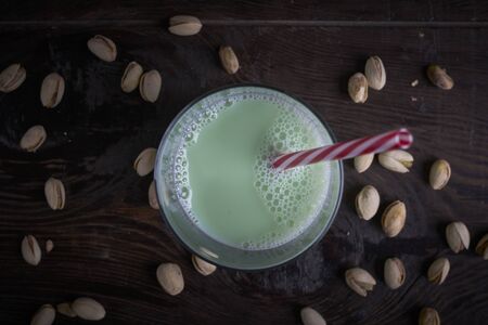 Pistachios milk on a wooden table.top viewの写真素材