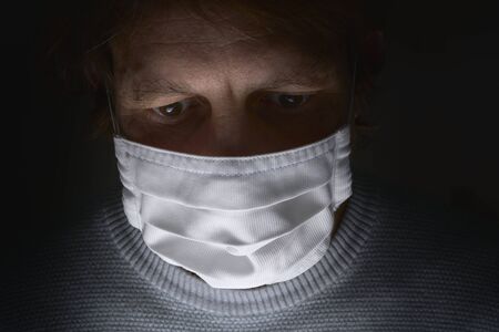 men in white aseptic respirator. Corona virus protection concept. with dark backgroundの写真素材
