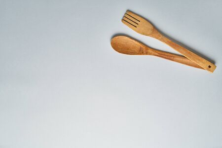 Top view of wooden kitchen spoon and fork. Top view
