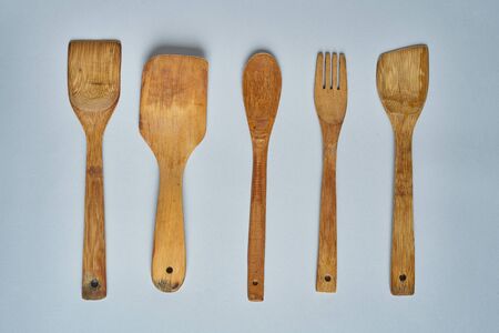 Empty wooden spoons and scoops on gray table. Top view.の写真素材