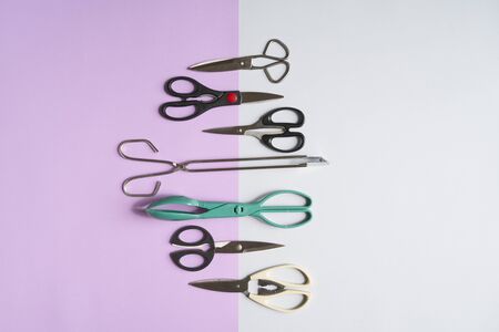 Various Types On Scissors On grey and pink background,top of view