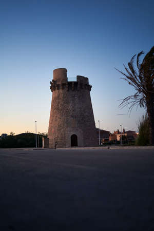 Old watch tower near the beach in Cullera, Valencia, Spain, verticalのeditorial素材
