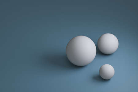 3d render, three white spheres with different sizes on blue background, copy spaceの写真素材