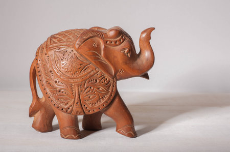 Close up of a decorative wooden elephant with shadow