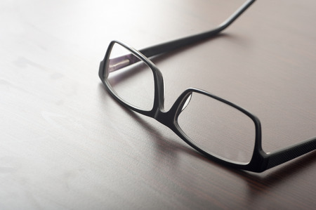Close up of reading glasses on coffee tableの写真素材