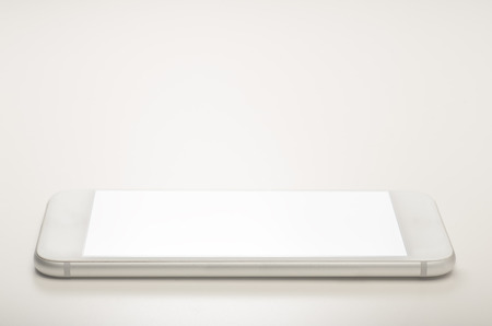 A smart phone isolated on white background with empty blank screenの写真素材