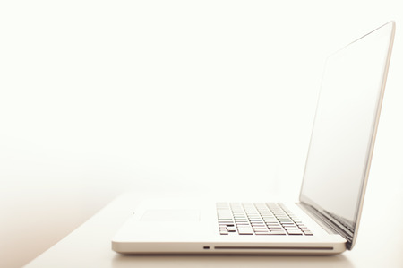 A modern lap top computer on desktop with shallow depth of field