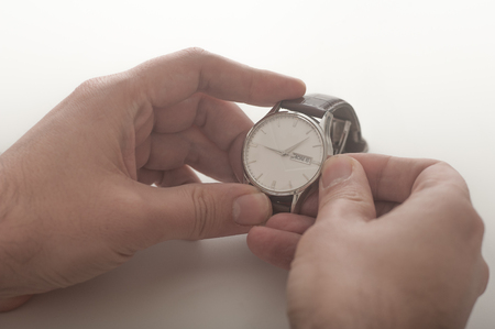 Close up of a man winding his wrist watchの写真素材