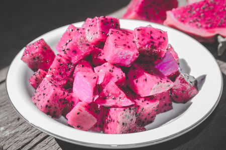 Slices of Red Dragon Fruit on Plate with Bokeh or Blur Effect Backgroundの写真素材