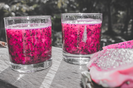 Red Dragon Fruit Juice in Cocktail Glass with Bokeh or Blur Effect Backgroundの写真素材