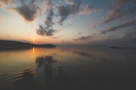 Calm Sea Water, Cloudy Sky and Beautiful Sunrise Morningの写真素材