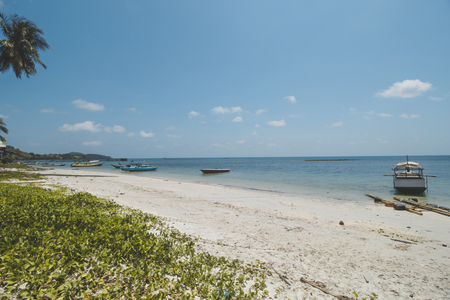 Clear Sea Water, White Sand, Cloudy Blue Sky and Tropical Beachの写真素材