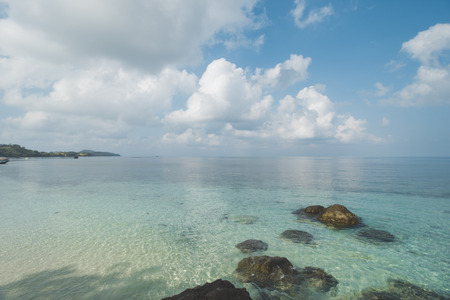 Cloudy Blue Sky, Granite Rock, Clear Sea Water and Tropical Beachの写真素材