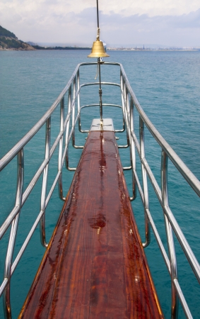 Ocean liner or sea yacht nose showing direction. Bell on cruise boat. Travel background.の写真素材