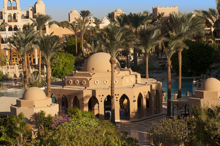 An oasis of palm trees and greenery photo. Houses along the beach in Makadi, Egyptの写真素材