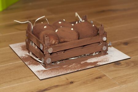 Brown chokolate sweet potato cake on a wooden dark background. Fudge nuggets with cream photoの写真素材