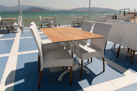 Cozy empty open cafe on the sea promenade photoの写真素材