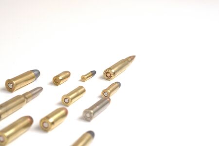Large bullet (7.62 x 51mm NATO) leading a group of smaller bullets on a white surface. It works as a...
