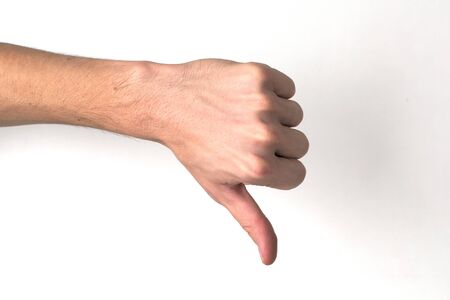 White ethnicity hand doing a thumb down sign against white background