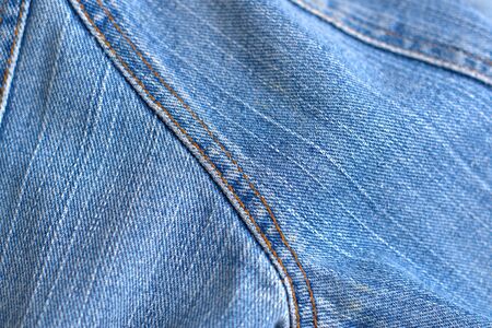 Blue worn denim texture detail close up.