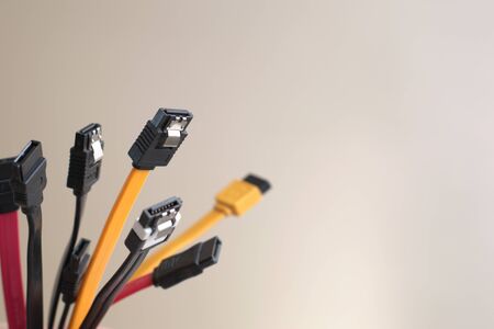 Red, black and yellow data cables on white background. Data storage, network server infrastructure concept. Plenty of negative space.の写真素材