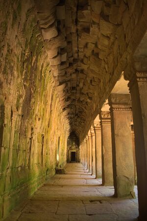 Inner gallery of Ta Prohm temple ruins, located in the Angkor Wat complex near Siem Reap, Cambodia.