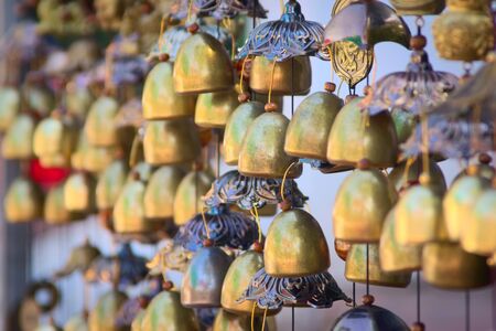 Traditional Lao chime bells at a stand in Luang Prabang, Laos.の写真素材