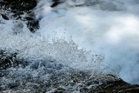 Clear, fresh stream of water splattering in a natural creek. Environmental, water conservation concept.の写真素材