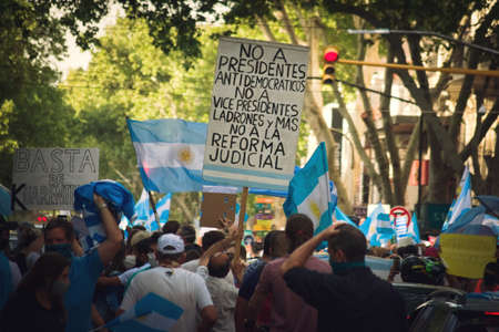 2020-10-12, Mendoza, Argentina: During a protest against the government, a man holds a sign reading "No to antidemocratic presidents, no to thieving vicepresidents, no to the judicial reform"のeditorial素材