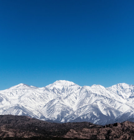 Snowy Andes mountains, as seen from Potrerillos, Mendoza, Argentina, in a sunny, bright winter day.の写真素材