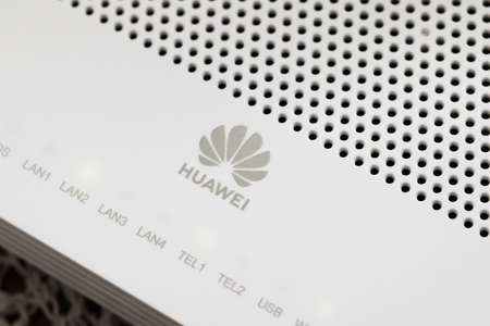 Huawei brand logo on the white plastic case of a modem router. Close up detail.のeditorial素材