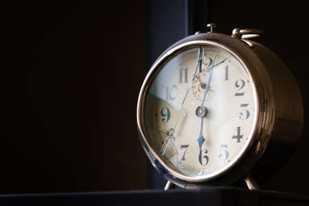 Old, broked mechanical alarm clock. Close up shot with negative space.