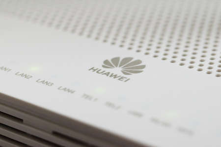 Huawei brand logo on the white plastic case of a modem router. Close up detail.