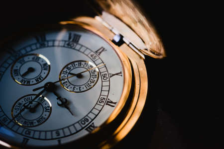 Golden luxury pocket watch. Extreme macro close up, black and white.の写真素材