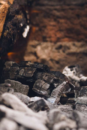 Smoldering embers and ashes in a bonfire. Close up.の写真素材