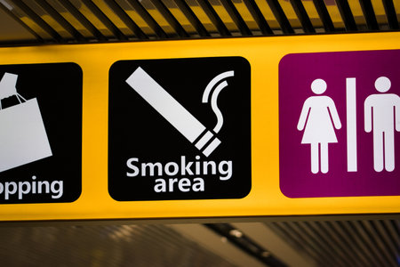 Information sign at an airport indicating the way to the smoking area.の写真素材