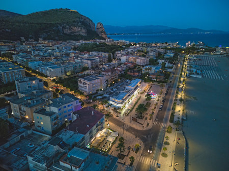Beaches of Terracina, Italy, at dusk. The Roman temple of Jupiter can be seen on top of the hill beyond the city.の写真素材