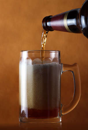 Freeze motion of pouring beer into glass pintの写真素材